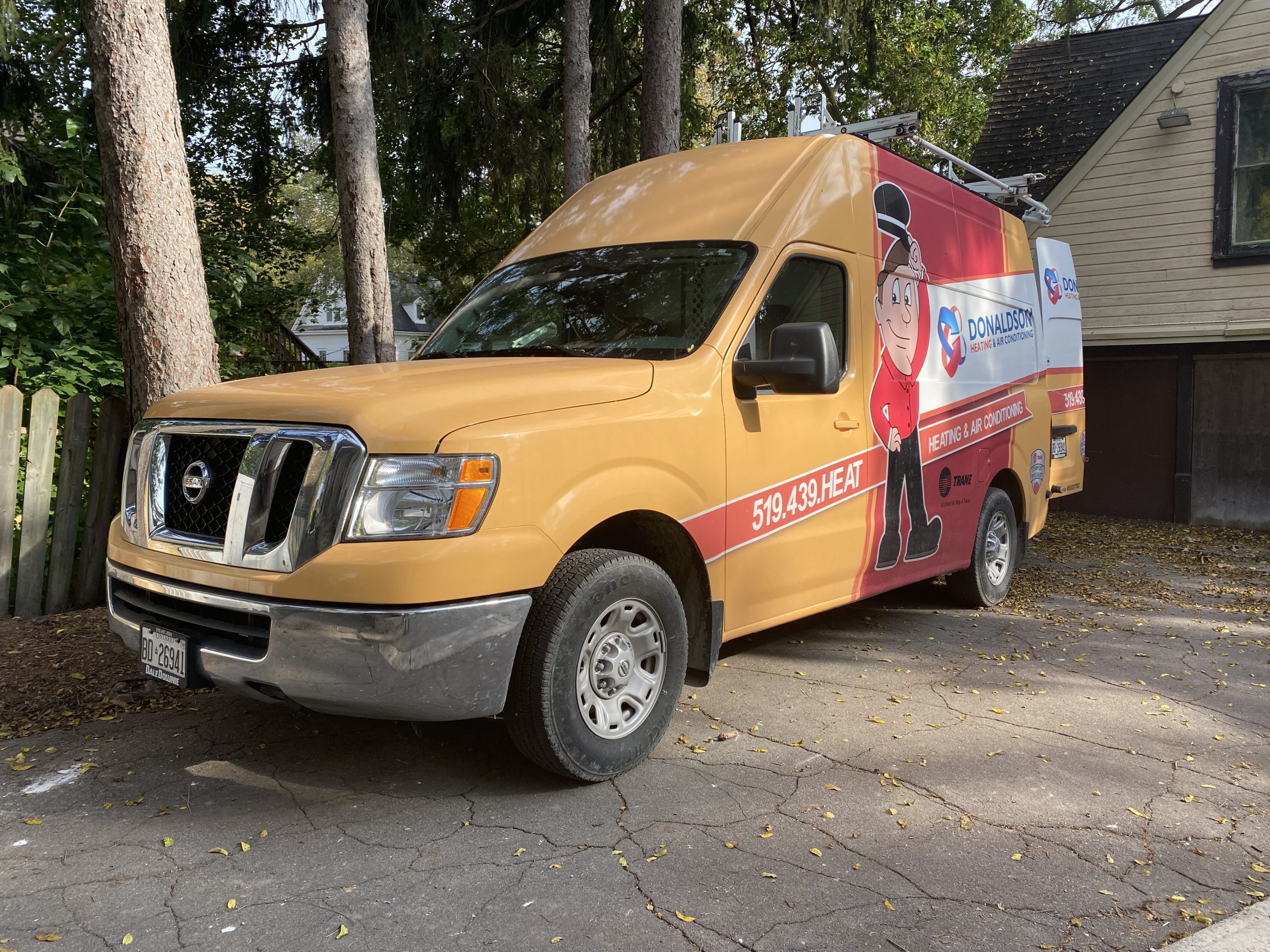 Donaldson technician providing HVAC service at a home.