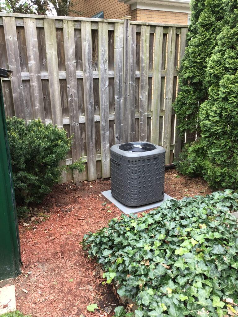 Continental Air Conditioner Unit beside fence in backyard.