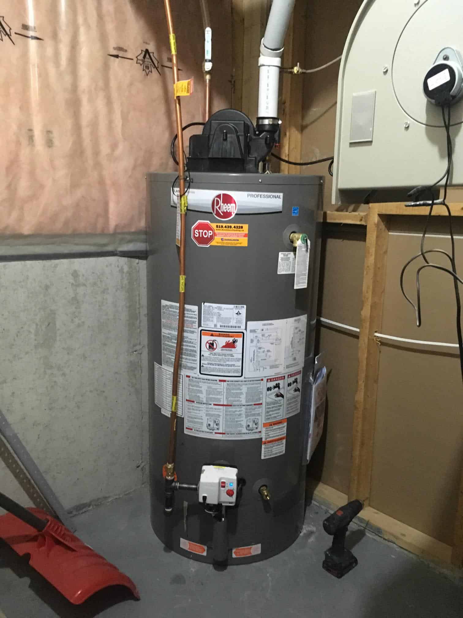 Donaldson Home Services Installed Reim Tanked Water Heater in corner of basement.