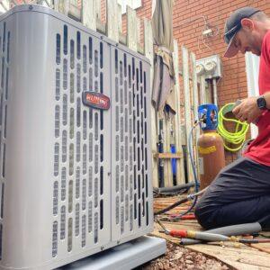 Man installing air conditioning unit outdoors