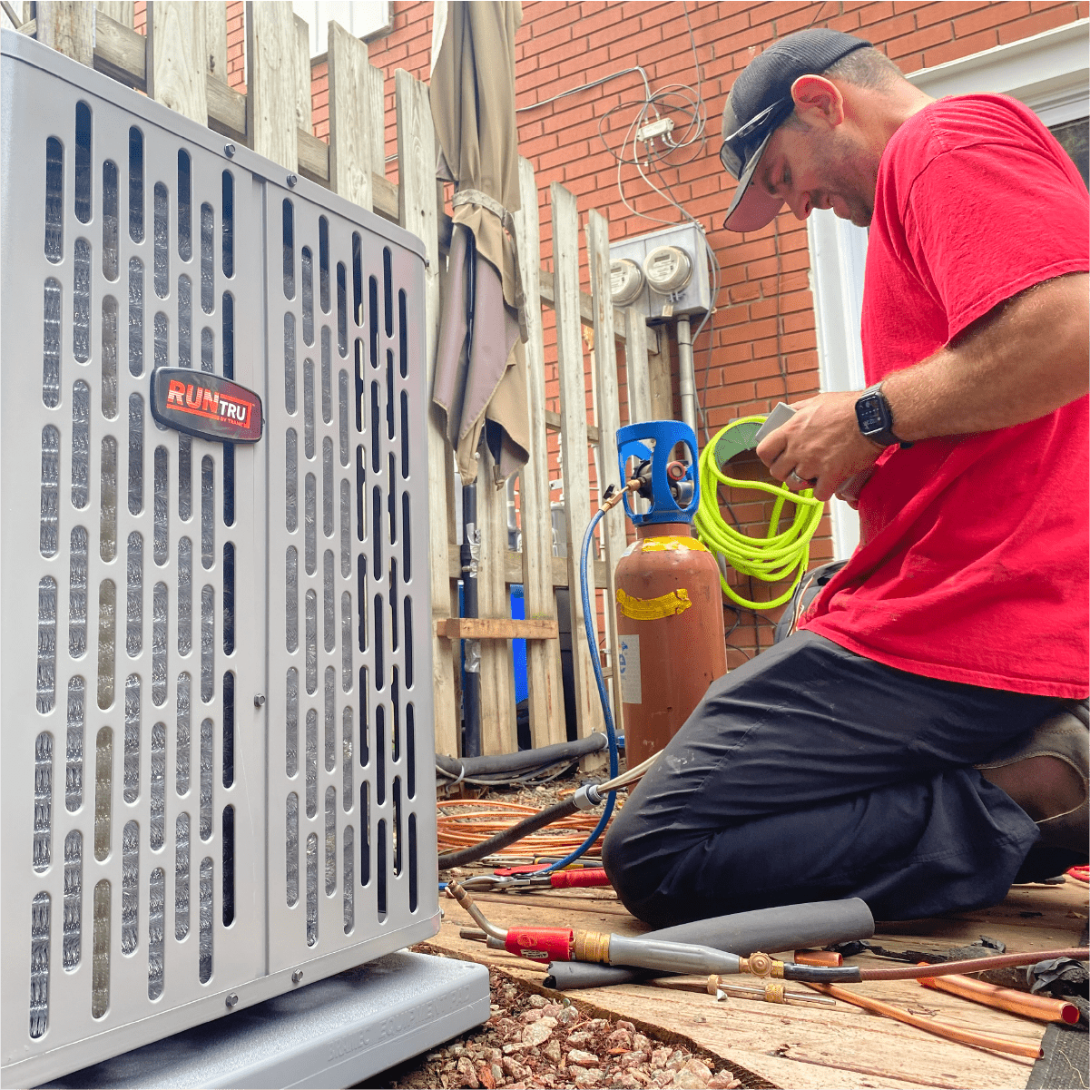 Best HVAC Brands. Donaldson technician installing a Trane Air Conditioner outside of London, Ontario home.