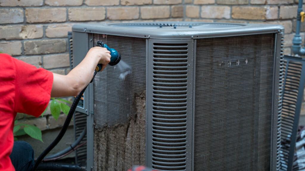 Donaldson Technician cleaning interor of an air conditioner in London ontario.