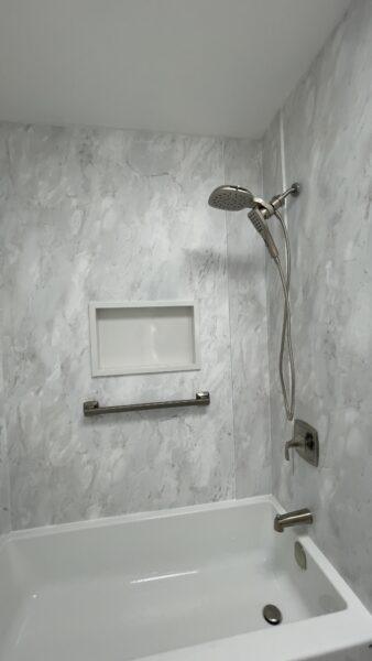 Newly remodeled shower with modern fixtures and acrylic