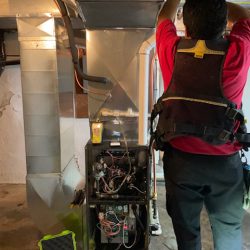 Donaldson technician performing HVAC service at a residential property.