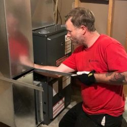Technician installing a furnace in a London, Ontario home.
